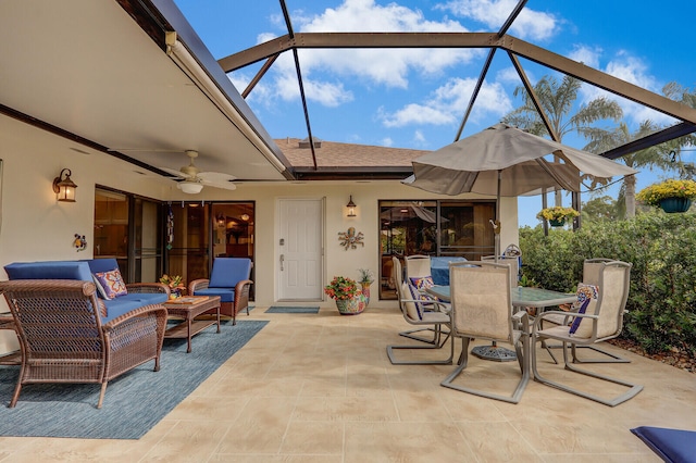 view of patio with glass enclosure, ceiling fan, and an outdoor living space