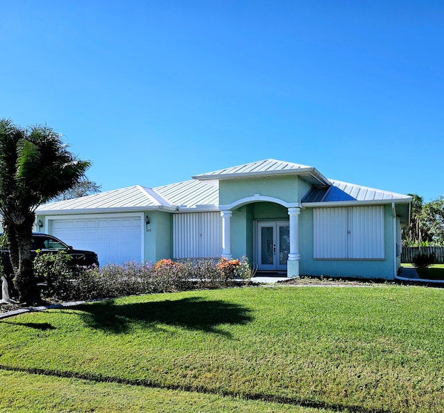 ranch-style house featuring a front lawn and a garage