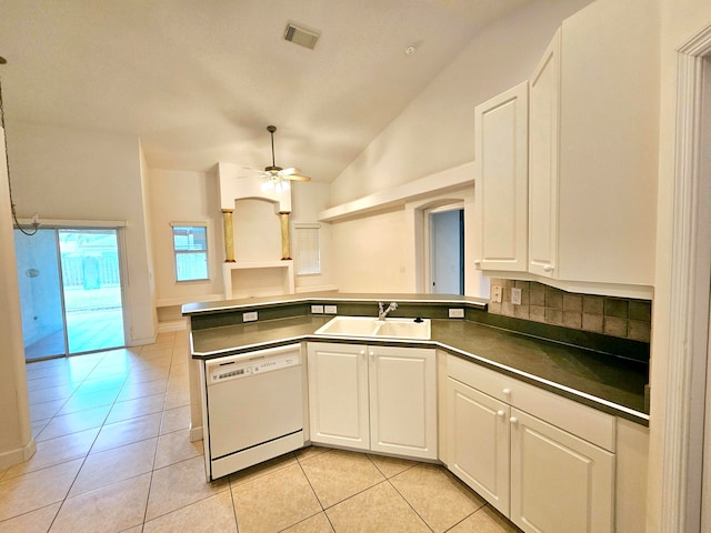 kitchen featuring white dishwasher, white cabinetry, sink, and light tile patterned floors