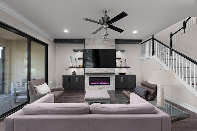 living room with crown molding, ceiling fan, dark hardwood / wood-style flooring, and a fireplace