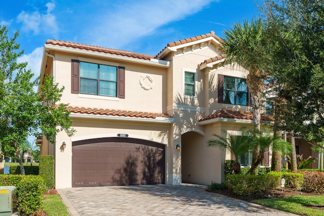 mediterranean / spanish home with a garage