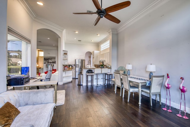 dining space with crown molding, dark hardwood / wood-style floors, and ceiling fan