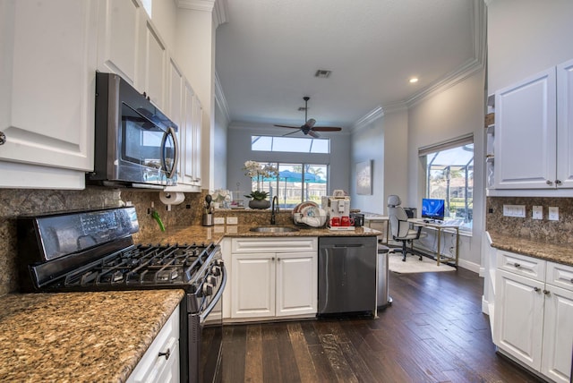 kitchen featuring gas stove, stainless steel dishwasher, and white cabinets