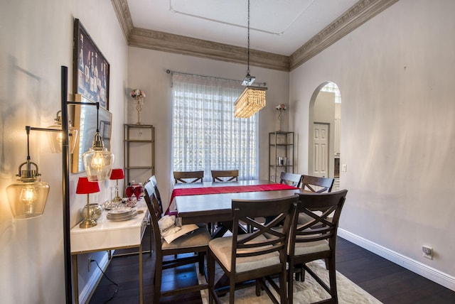 dining area featuring crown molding and dark hardwood / wood-style floors