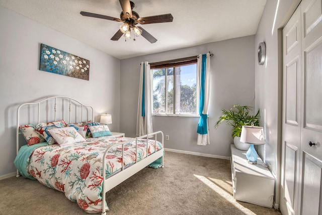 carpeted bedroom featuring ceiling fan and a closet