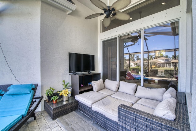 view of patio featuring outdoor lounge area, ceiling fan, and glass enclosure