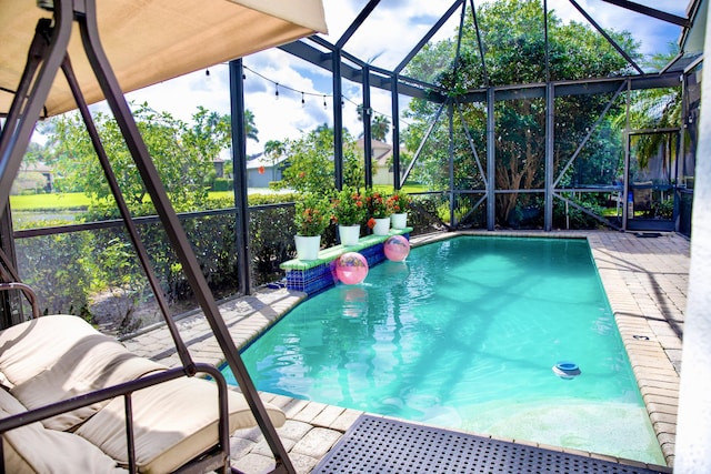 view of swimming pool featuring a lanai and a patio