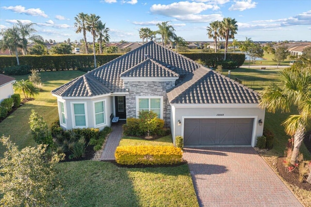 view of front of property with a front yard and a garage