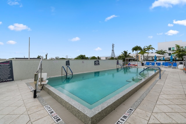 view of swimming pool with a patio