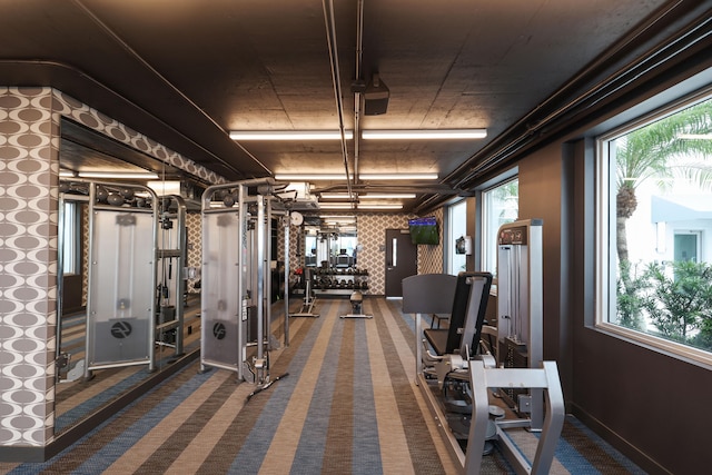 exercise room featuring dark colored carpet