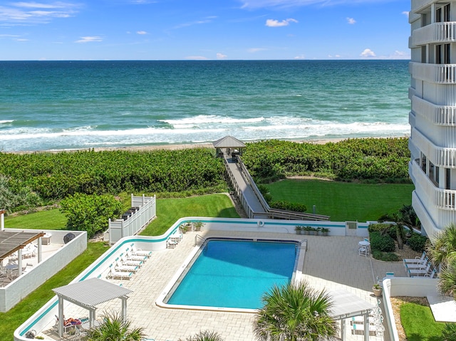 view of swimming pool featuring a patio area and a water view