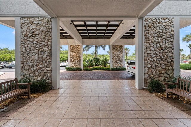 hallway with french doors, a paneled ceiling, and elevator