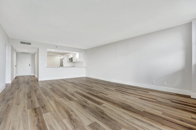 unfurnished living room featuring light hardwood / wood-style flooring