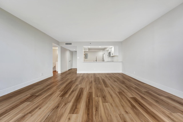 unfurnished living room with hardwood / wood-style flooring