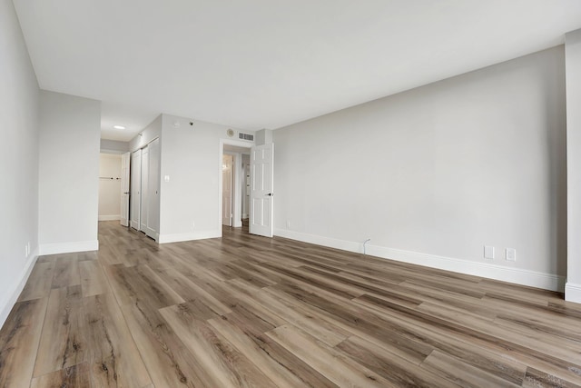 spare room featuring light hardwood / wood-style flooring