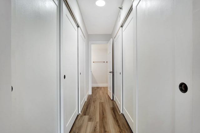 hall with light hardwood / wood-style flooring