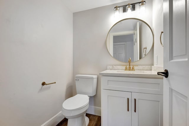 bathroom featuring wood-type flooring, vanity, and toilet