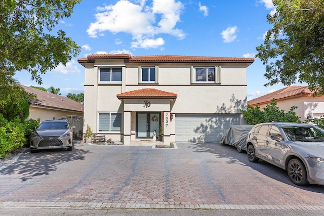 mediterranean / spanish home with a garage