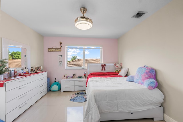 bedroom featuring multiple windows and light tile patterned floors