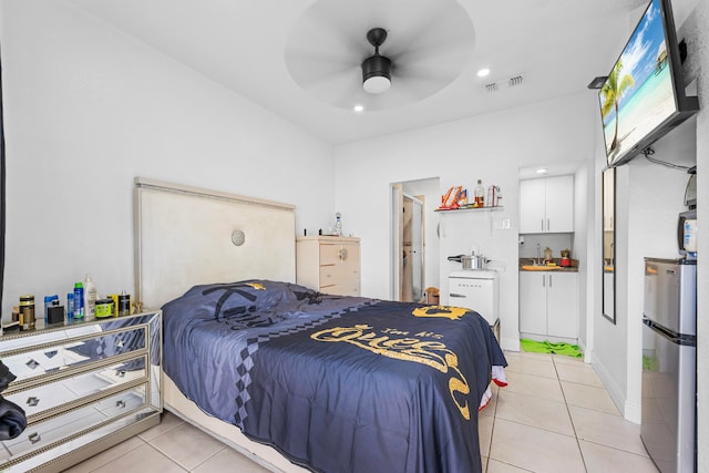 bedroom featuring light tile patterned floors, stainless steel refrigerator, ceiling fan, and sink