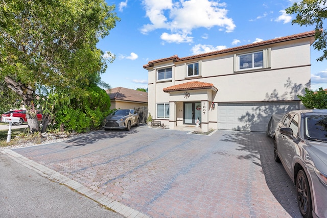 mediterranean / spanish house with a garage