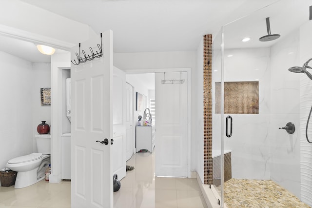 bathroom with tile patterned flooring, a shower with shower door, and toilet