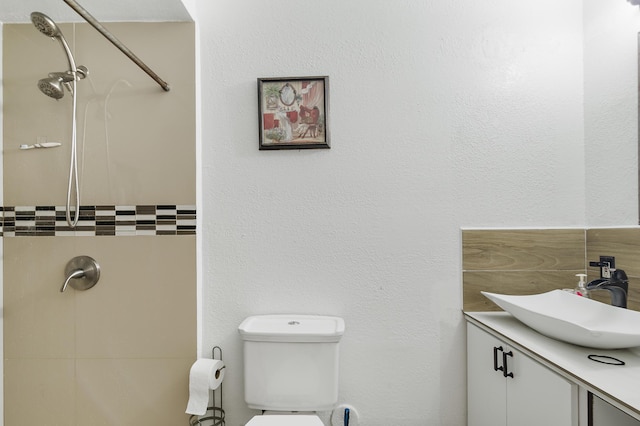 bathroom featuring vanity, toilet, and a shower