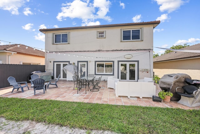 rear view of house featuring a patio area and french doors