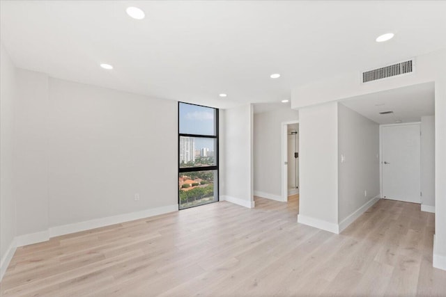 unfurnished room featuring light hardwood / wood-style flooring