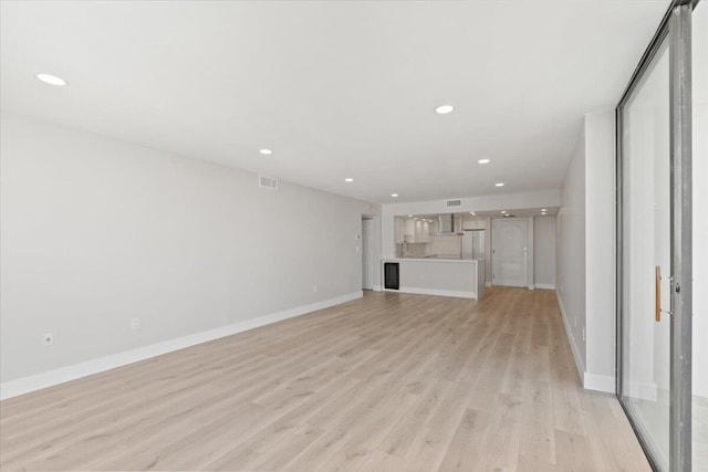 unfurnished living room featuring light wood-type flooring