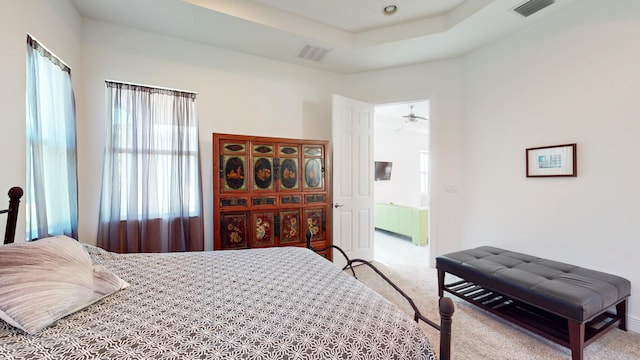 bedroom featuring carpet flooring, multiple windows, and radiator