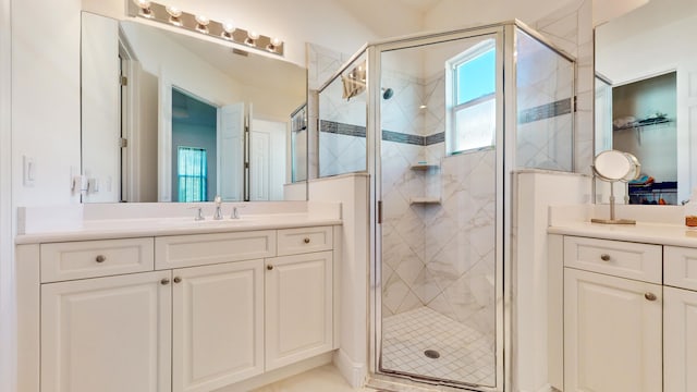 bathroom featuring vanity and a shower with door