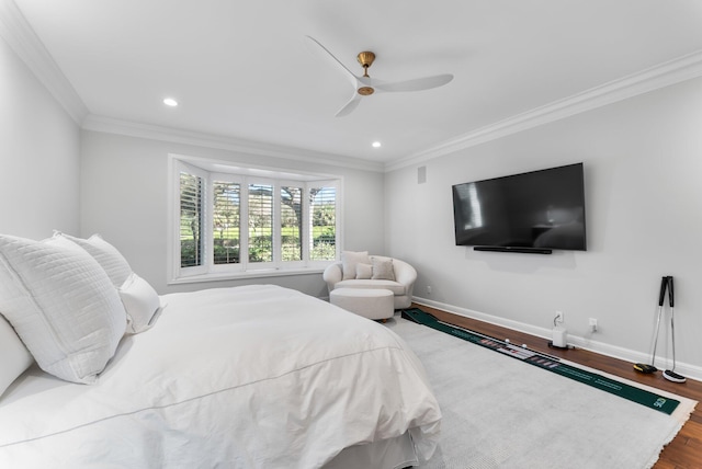 bedroom featuring ceiling fan, ornamental molding, and hardwood / wood-style flooring