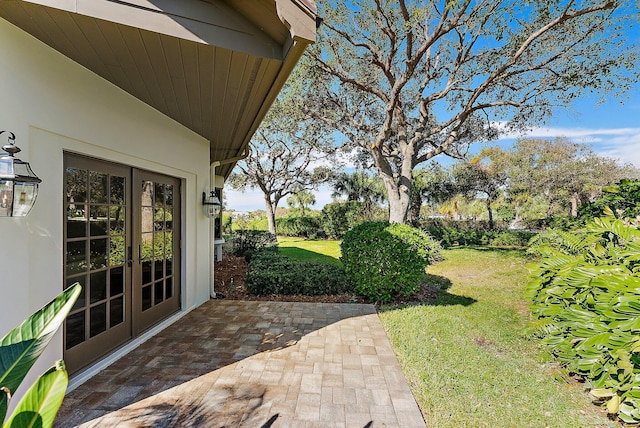 view of yard with french doors and a patio