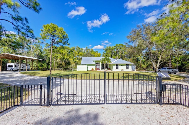 view of gate with a yard