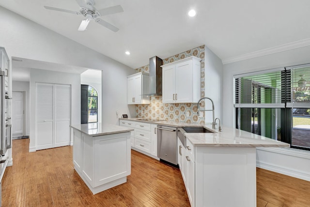 kitchen featuring dishwasher, light hardwood / wood-style floors, white cabinetry, and wall chimney exhaust hood