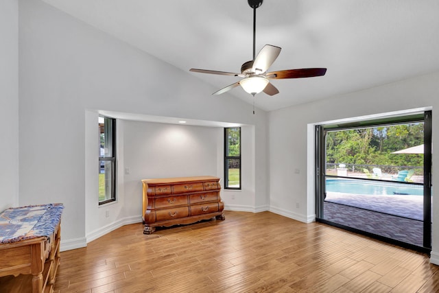 sitting room with ceiling fan, a healthy amount of sunlight, vaulted ceiling, and light wood-type flooring