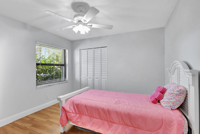 bedroom featuring ceiling fan, light hardwood / wood-style floors, and a closet