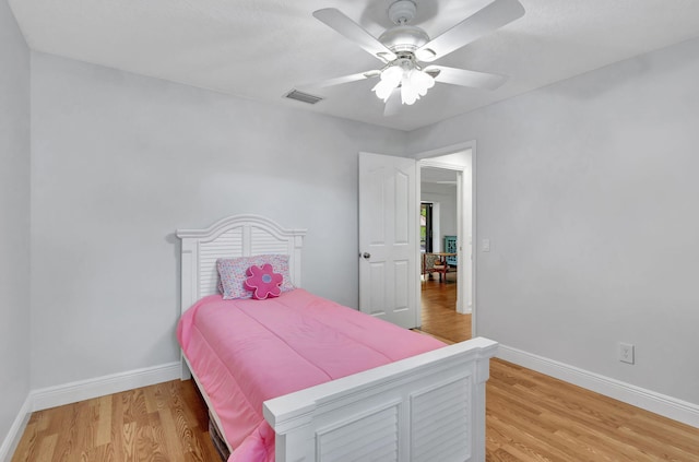 bedroom with hardwood / wood-style floors and ceiling fan