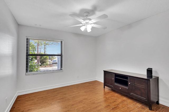 spare room featuring ceiling fan and light hardwood / wood-style flooring