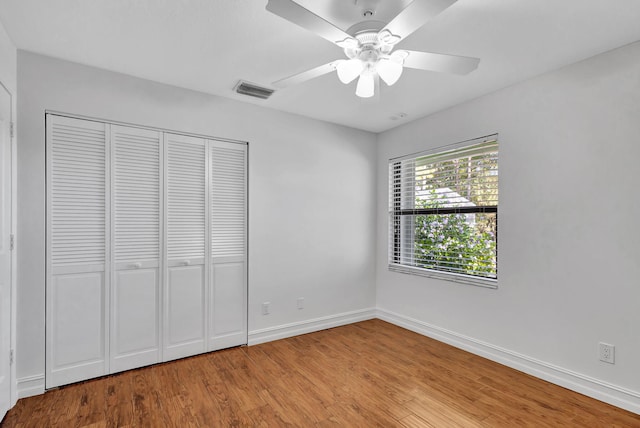 unfurnished bedroom with a closet, ceiling fan, and light hardwood / wood-style flooring