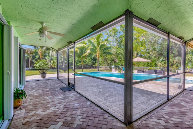 view of swimming pool with ceiling fan and a patio