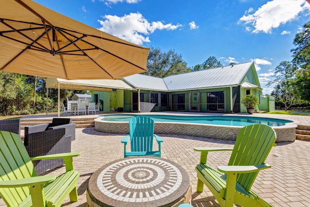 view of pool featuring a patio area and an in ground hot tub