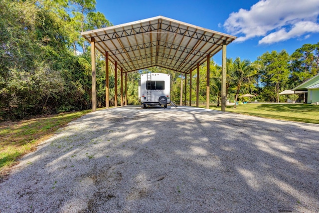 view of car parking featuring a carport and a lawn