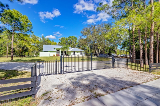 view of gate featuring a lawn