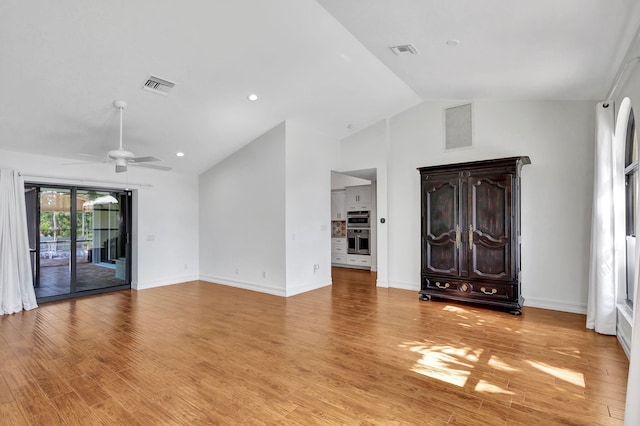 foyer entrance featuring ceiling fan, high vaulted ceiling, and light wood-type flooring