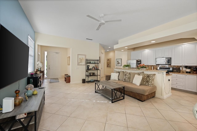 living room featuring ceiling fan and light tile patterned floors