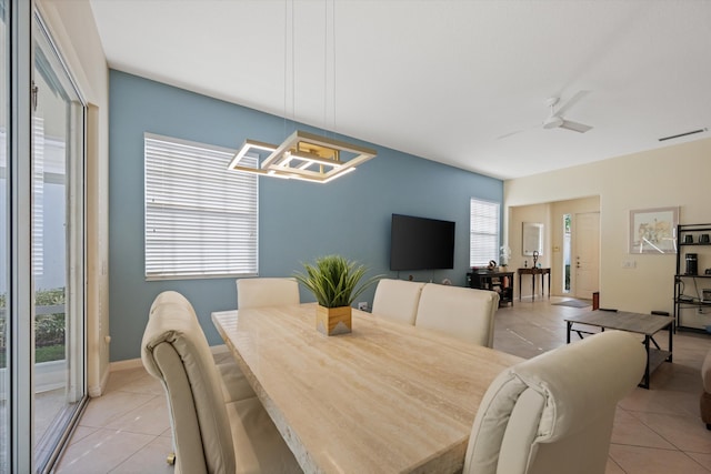 tiled dining room with ceiling fan and a healthy amount of sunlight