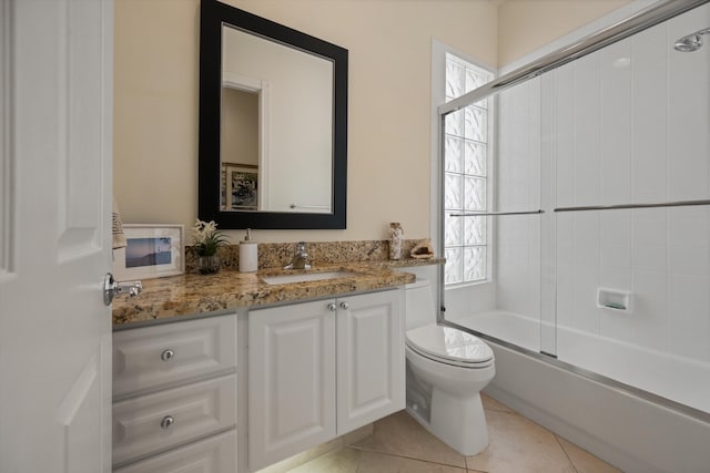 full bathroom with tile patterned floors, vanity, enclosed tub / shower combo, and toilet