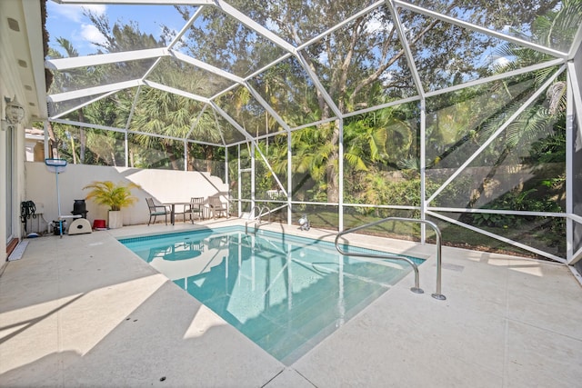 view of swimming pool featuring a patio and glass enclosure